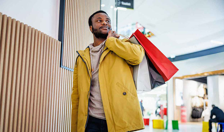 Man holding a shopping bag, representing SLB employee discount benefits