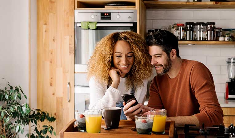 Smiling couple looking at a phone together