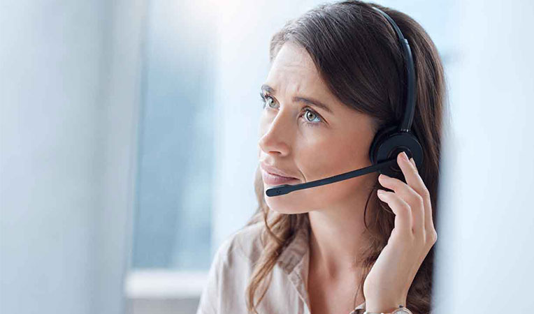 Woman wearing headphones, representing SLB provincial service support.