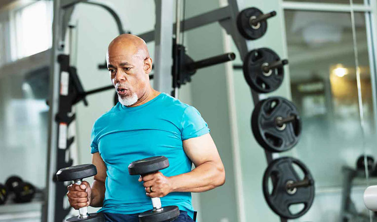 Fit older man exercising in gym, symbolizing SLB spending account benefits.