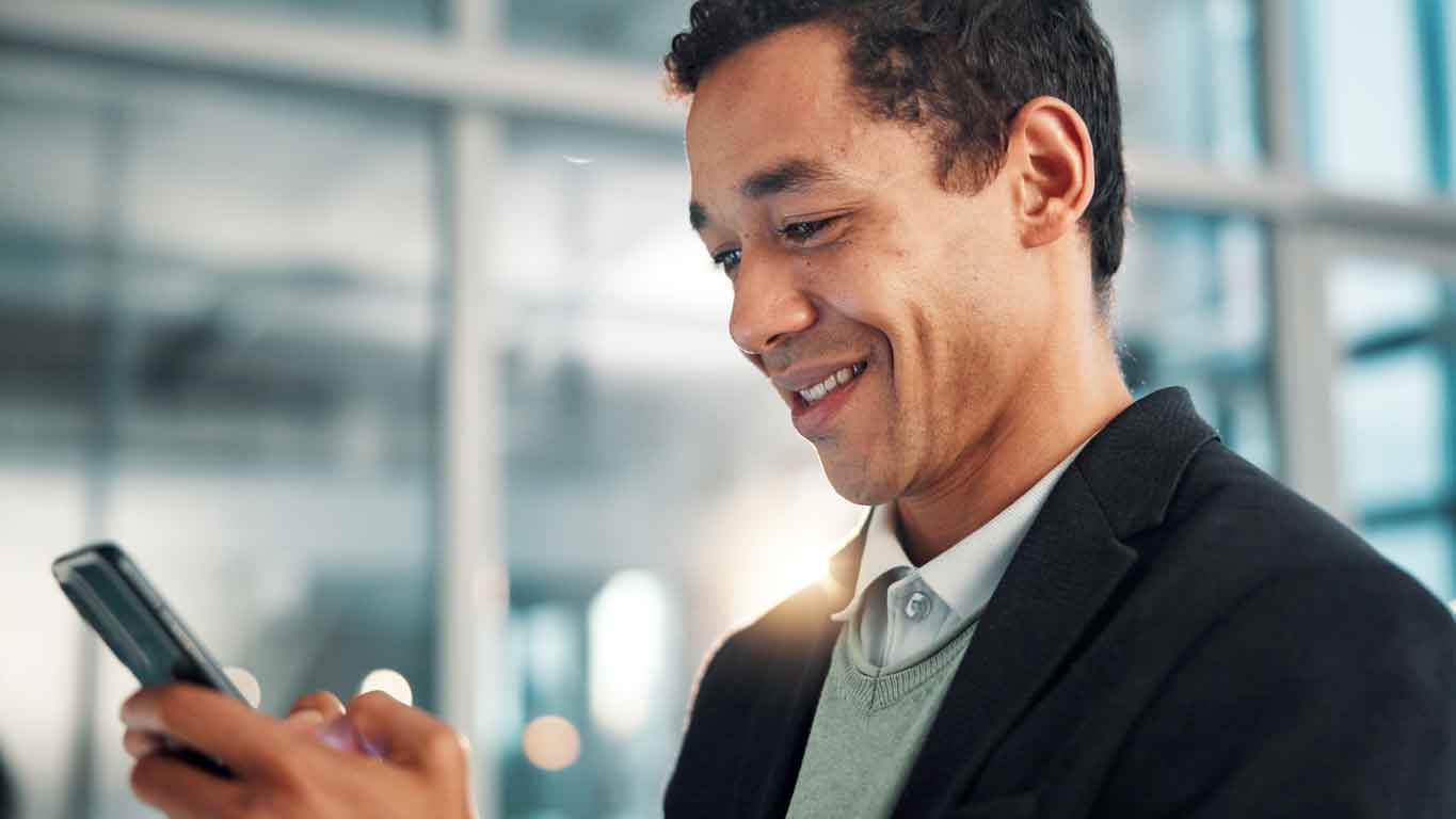 Person smiling while using a phone, symbolizing discounted stock purchase plan